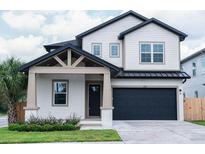 Two-story craftsman style home with gray siding at 213 W Giddens Ave, Tampa, FL 33603