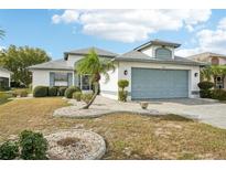 Single-story home with a two-car garage and landscaped front yard at 1830 E Del Webb Blvd, Sun City Center, FL 33573