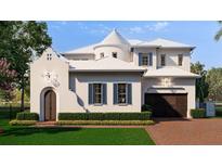 Stunning two-story home featuring a white exterior, unique architectural details, and a well-manicured front yard at 5009 W Spring Lake Dr, Tampa, FL 33629