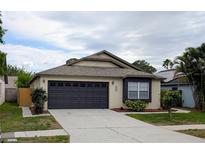Charming single-story home featuring a two-car garage, well-maintained landscaping, and a welcoming entrance at 1442 Tiverton Dr, Brandon, FL 33511