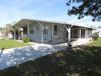Single-wide manufactured home with covered porch at 37241 Cora Ave, Zephyrhills, FL 33542