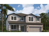 Two-story home with a gray exterior, stone accents, and a two-car garage at 228 Hillshire Pl, Spring Hill, FL 34609