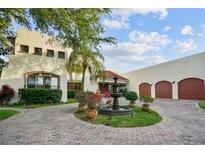 Two-story home with fountain and three-car garage at 7306 Pelican Island Dr, Tampa, FL 33634