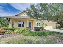 Beautiful yellow house with a landscaped yard and inviting front porch at 6619 Current Dr, Apollo Beach, FL 33572