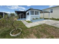 Charming single-story home with a well-maintained front yard and a cozy, screened-in porch at 116 W Saint Johns Way, Apollo Beach, FL 33572