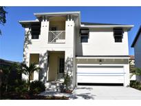 Charming two-story home featuring a clean white exterior and an attached two-car garage at 7205 S De Soto St, Tampa, FL 33616