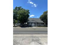 Gray house with mature trees and street view at 3008 N Nebraska Ave, Tampa, FL 33603