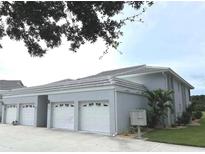 Condo building with attached garages and a community mailbox at 1041 Capri Isles Blvd # 219, Venice, FL 34292