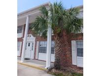 Brick building exterior with white columns and palm trees at 4507 9Th W St # E8, Bradenton, FL 34207