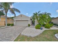 One-story home with a two-car garage and landscaped yard at 804 Regal Manor Way, Sun City Center, FL 33573
