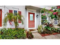 Front entrance with red door and lush landscaping at 11310 Stratton Park Dr # 1, Temple Terrace, FL 33617