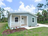 Single-story home with gray siding, white trim, and a front porch at 17476 Quentin Ave, Port Charlotte, FL 33954