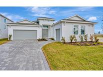 Two-story house with gray garage doors and a paved driveway at 8328 Golden Beach Ct, Parrish, FL 34219