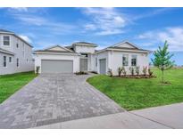 Elegant single-story home with a neatly paved driveway and manicured front lawn at 8328 Golden Beach Ct, Parrish, FL 34219