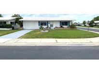 Ranch-style home with a well-manicured lawn at 10032 36Th N St, Pinellas Park, FL 33782