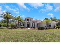 Two story house with double doors and lush landscaping at 6218 Bridleford Dr, Wesley Chapel, FL 33545