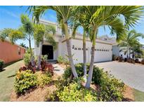 Inviting two-story home with lush landscaping, a paver driveway, and a two-car garage at 5243 Wishing Arch Dr, Apollo Beach, FL 33572