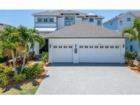 Two-story house with white exterior and two-car garage at 5243 Wishing Arch Dr, Apollo Beach, FL 33572