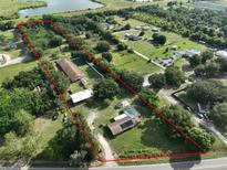 Expansive aerial view of property with a large lot, pool, and several structures at 12922 672 Hwy, Riverview, FL 33579