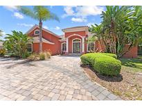 Two-story home with red exterior and brick driveway at 614 Vintage Way, Brandon, FL 33511