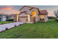 Two-story house with a landscaped yard and attached garage at 12711 Royal George Ave, Odessa, FL 33556
