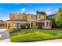 Two story yellow brick home with a large yard at 803 Bayshore Blvd, Tampa, FL 33606
