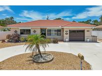 Single-story home with circular driveway and landscaping at 186 45Th Ave, St Pete Beach, FL 33706