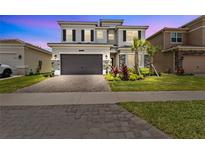 Two-story home with two-car garage and landscaping at 32588 Tree Of Life Ave, Wesley Chapel, FL 33543