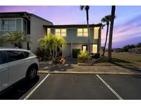 Evening view of condo building exterior, showcasing landscaping and parking at 1028 Apollo Beach Blvd # 27, Apollo Beach, FL 33572