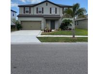Two-story house with a two-car garage and landscaping at 462 Spotted Slipper Pl, Ruskin, FL 33570
