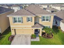 Two-story house with driveway and landscaping at 30989 Summer Sun Loop, Wesley Chapel, FL 33545