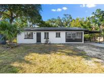 Newly renovated home featuring a white exterior, dark-grey accents and a carport at 2504 38Th W Ave, Bradenton, FL 34205