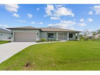 Single-story home with a two-car garage and well-manicured lawn at 9171 Prospect Ave, Englewood, FL 34224