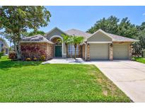 Beautiful two-story house with stone accents and a lush lawn at 805 Woodcarver Ln, Brandon, FL 33510