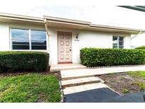 Updated condo exterior with manicured hedges and a welcoming entrance at 2220 Grenadier Dr # 2220, Sun City Center, FL 33573
