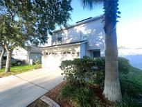 Two-story house with a two-car garage and landscaping at 3316 Thistledown Ln, Land O Lakes, FL 34638