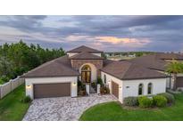 Luxury home with two-car garage and paver driveway at 7876 Roma Dune Dr, Wesley Chapel, FL 33545