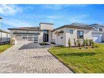 Modern two-story house with paver driveway and landscaped lawn at 8320 Golden Beach Ct, Parrish, FL 34219