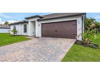 Modern house exterior with a paved driveway at 5473 Colfax Ter, Port Charlotte, FL 33981