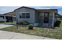 Mobile home with carport and landscaped yard at 1710 7Th Sw St # 103, Ruskin, FL 33570