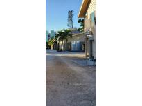 Exterior view of the property showing a building and a palm tree at 5053 N Beach Rd # 9, Englewood, FL 34223