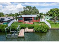 Aerial view of waterfront home with private dock and lush landscaping at 429 Flamingo Dr, Apollo Beach, FL 33572
