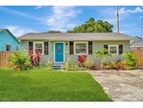 Charming bungalow with a teal door, landscaping, and a spacious yard at 2866 15Th N Ave, St Petersburg, FL 33713