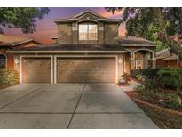 Two story home with three car garage and landscaping at 11140 Oyster Bay Cir, New Port Richey, FL 34654