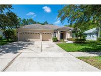 Spacious home with three-car garage and landscaped yard at 6120 Cezanne Ave, Lutz, FL 33558