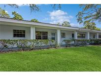 Exterior view of a light-colored building with a neatly landscaped lawn at 11200 102Nd Ave # 60, Seminole, FL 33778