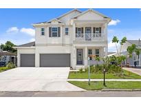Beautiful two-story home with a manicured lawn, a two-car garage, and inviting front porch at 4017 W Fig St, Tampa, FL 33609