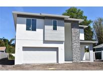 Modern two-story home featuring a gray and white color scheme and stacked stone accent wall at 707 W Fribley St, Tampa, FL 33603