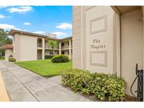The Tangier building exterior with landscaping at 19029 Us Highway 19 N # 4-5, Clearwater, FL 33764