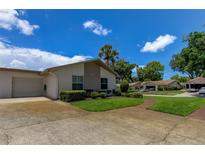 Single story home with landscaped lawn and attached garage at 3283 Hilary Cir # 2C, Palm Harbor, FL 34684